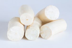 Fresh Cassava root peeled. Isolated on white background. Copy space.